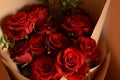 Bouquet of lush beautiful fresh red roses in kraft paper. Happy valentine`s day.