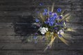 A bouquet of meadow wild flowers, top view, on a dark wooden background Royalty Free Stock Photo