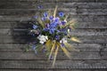 A bouquet of meadow wild flowers, top view, on a dark wooden background Royalty Free Stock Photo