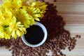 Bouquet of meadow yellow flowers. A Cup of coffee on the table. Royalty Free Stock Photo