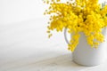 Bouquet of mimosa flowers on white wooden background. Springtime Royalty Free Stock Photo