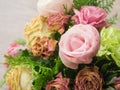 Bouquet of mixed flowers on wood background, Roses, Carnation, Eustoma, dry flowers