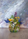 Bouquet of mixed spring flowers in a little glass, round vase. Corydalis cava, Muscari armeniacum, camomile, dandelion in a vase Royalty Free Stock Photo