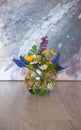 Bouquet of mixed spring flowers in a little glass, round vase Royalty Free Stock Photo