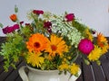 Bouquet of modest summer meadow and garden flowers in the ceramic vase on the wooden table,close up Royalty Free Stock Photo