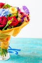 Bouquet of multicolored roses on wooden table Royalty Free Stock Photo