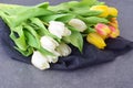 Bouquet of multicolored tulips on a grey cloth. Spring flowers. Romance Royalty Free Stock Photo