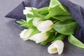 Bouquet of multicolored tulips on a grey cloth. Spring flowers. Romance Royalty Free Stock Photo