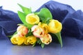 Bouquet of multicolored tulips on a grey cloth. Spring flowers. Romance Royalty Free Stock Photo