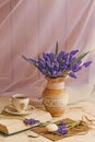 Bouquet of muscari flowers in a vintage vase. Cup of coffee, book and romantic flowers. Royalty Free Stock Photo