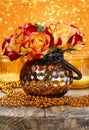 Bouquet of orange and red roses in golden vase Royalty Free Stock Photo