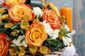 Bouquet of orange roses and ivory carnation flowers