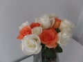 Bouquet of orange and white roses in a glass vase Royalty Free Stock Photo