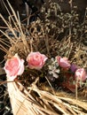 Bouquet of pale pink cream roses in a woven basket on a windowsill. Soft focus. Romance background with copy space Royalty Free Stock Photo