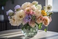 a bouquet of pastel flowers in a clear vase