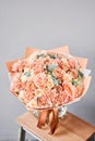 Bouquet Peach and orange color. Beautiful bunch mixed flowers in wooden table. the work of the florist at a flower shop Royalty Free Stock Photo