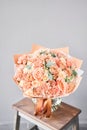 Bouquet Peach and orange color. Beautiful bunch mixed flowers in wooden table. the work of the florist at a flower shop