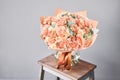 Bouquet Peach and orange color. Beautiful bunch mixed flowers in wooden table. the work of the florist at a flower shop