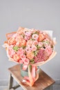 Bouquet Peach and orange color. Beautiful bunch mixed flowers in wooden table. the work of the florist at a flower shop