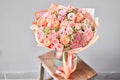 Bouquet Peach and orange color. Beautiful bunch mixed flowers in wooden table. the work of the florist at a flower shop