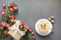 Bouquet of pink bush roses, female gift and cup of coffee on shabby chic background, top view point. Copy space. Mother`s day bac Royalty Free Stock Photo