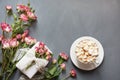 Bouquet of pink bush roses, female gift and cup of coffee on shabby chic background, top view point. Copy space. Mother`s day bac Royalty Free Stock Photo