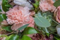 Bouquet with pink carnations and other flowers and green leaves Royalty Free Stock Photo