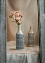 Bouquet of Pink flowers in Blue handmade ceramic vases in Wooden frame on Blush textured table cloth