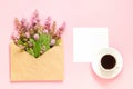 Bouquet of pink flowers in envelope, cup of coffee and a white blank card for text on pink background Concept Good morning or Royalty Free Stock Photo