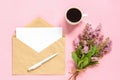 Bouquet of pink flowers, envelope with white blank card for text and cup of coffee on pink background Greeting card Flat Lay Mock Royalty Free Stock Photo