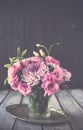 Bouquet of pink flowers in vase vintage decor Royalty Free Stock Photo