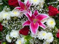 Bouquet of pink fresh lilies and white golden daisy.