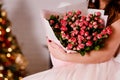 Bouquet of pink mini roses in women`s hands