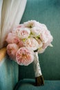 Bouquet of pink peonies propped on a chair Royalty Free Stock Photo