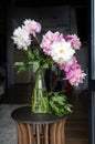 Bouquet of pink peonies. Vase with peonies on the table.