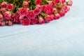 Bouquet of pink roses on a blue surface Royalty Free Stock Photo