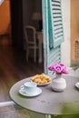 A bouquet of pink roses, croissants and coffee. French Breakfast on the balcony Royalty Free Stock Photo