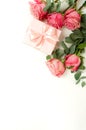 Bouquet of pink roses flowers, gift box  isolated on white background with copy space. Royalty Free Stock Photo