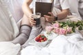 A bouquet of pink roses, in the hands of a girl`s book, Berries of strawberries and fragrant coffee Espresso in the morning. Royalty Free Stock Photo