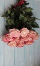 A bouquet of pink roses lies on a wooden surface. Royalty Free Stock Photo