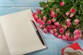 Bouquet of pink roses with an open notebook Royalty Free Stock Photo