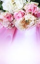 A bouquet of pink roses and peonies on a light pink background. A delicate festive floral arrangement. Royalty Free Stock Photo