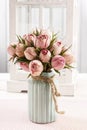 Bouquet of pink roses in turquoise ceramic vase