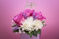 Bouquet of pink roses and white flowers on a pink background with white word Love Royalty Free Stock Photo
