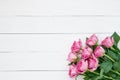 Bouquet of pink roses on white wooden background. Top view, copy