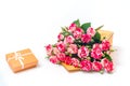 Bouquet of pink roses is in wooden box with a gift on a white background. Flowers are horizontal close-up Royalty Free Stock Photo