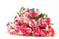 Bouquet of pink roses is in wooden box on a white background. Flowers are horizontal close-up