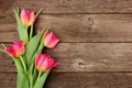 Bouquet of pink tulip flowers against a rustic wood background Royalty Free Stock Photo