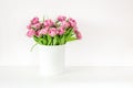 Bouquet of pink tulips in bucket. Fresh spring easter flower. White background , copy space