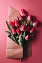 Bouquet of pink tulips in envelope on red background. Royalty Free Stock Photo